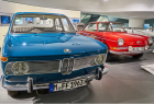 Classic Blue and Red Volkswagen Cars in a Museum