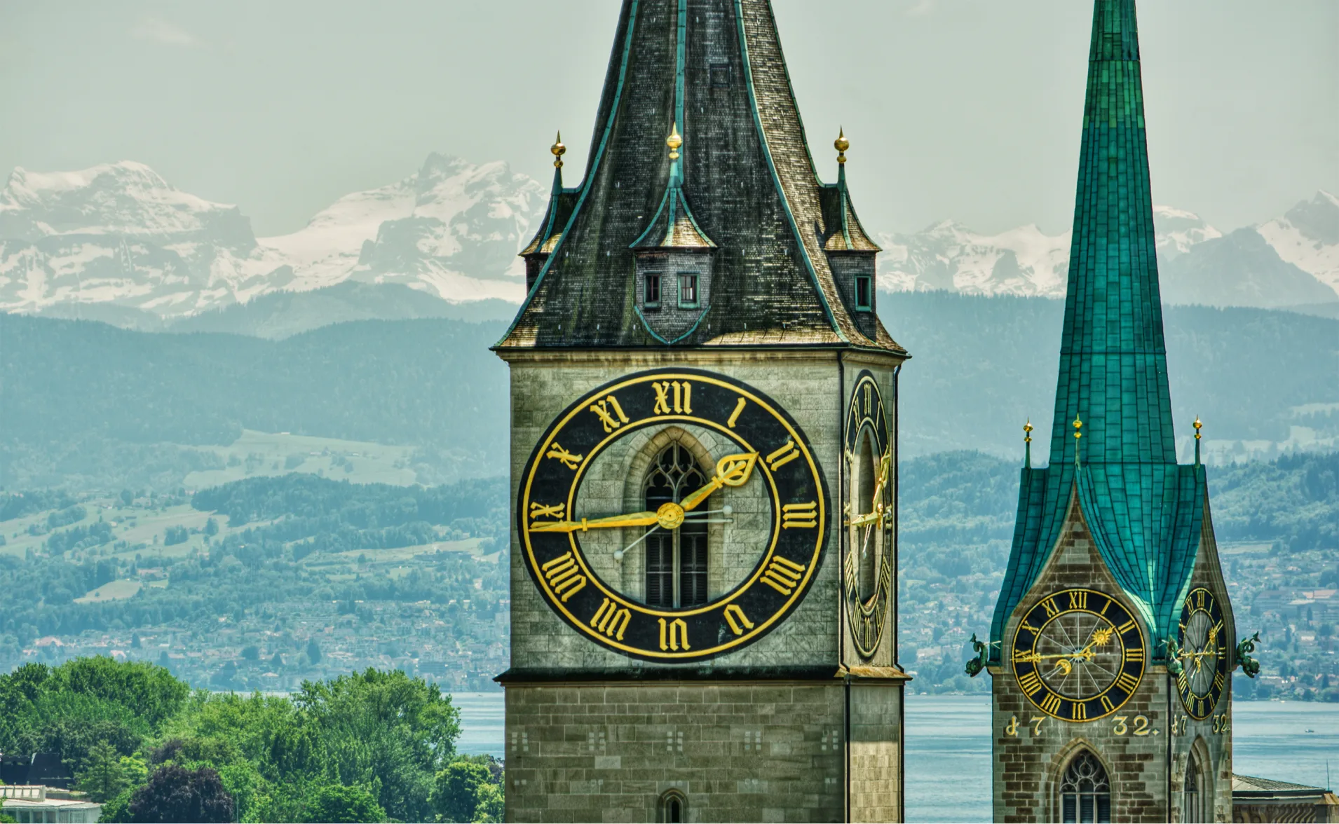 st peter clocktower in zurich with mountain backdrop