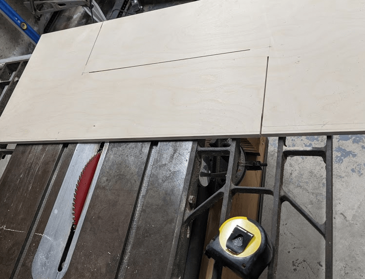 Picture of two intersecting "L" cuts of wood on a circular saw bench