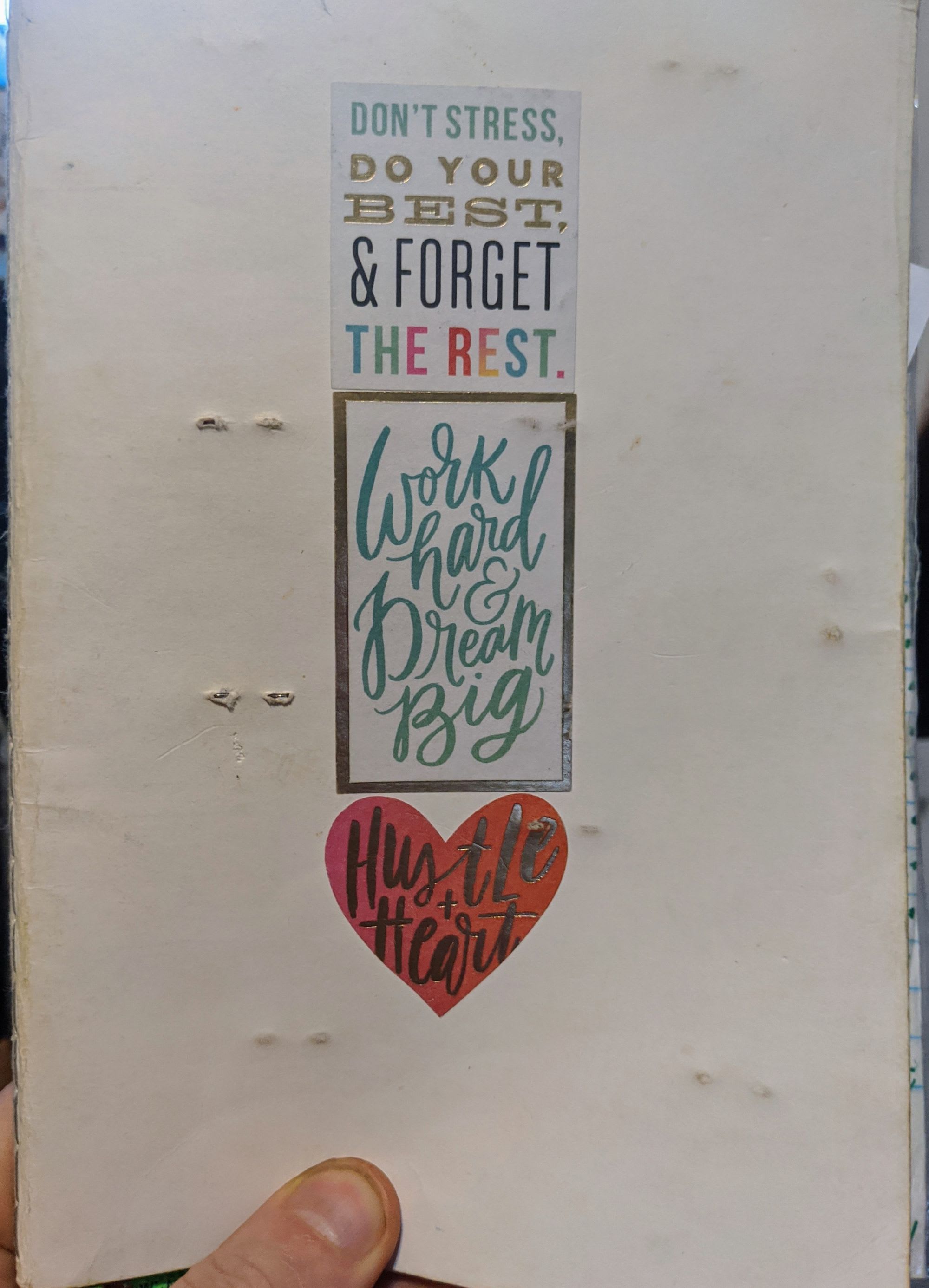 Cover of a bullet journal with stickers that say, "Hustle and Heart", and "Work Hard and Dream Big".