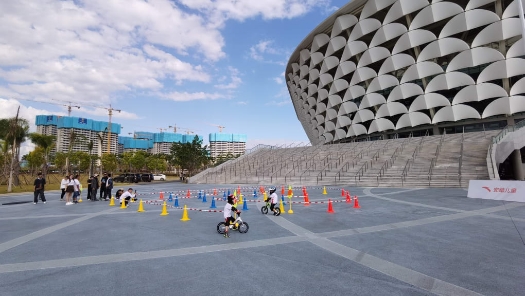 Exterior view of children cycling outside the Stadium of Sanya International Sports Industry Park