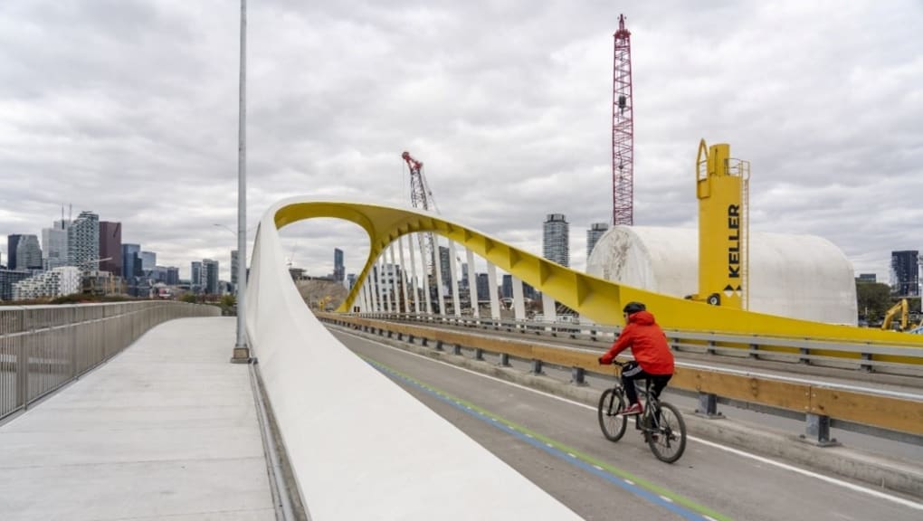 A cyclist crossing the Port Lands Bridges. Copyright Waterfront Toronto, Vid Ingelevics, Ryan Walker, 2023