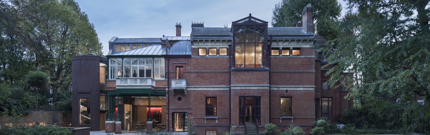 Front view of a two-storey red brick historic house.