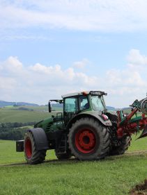 Packers - Kverneland Packomat compact and transported above ground level, dragged by tractor in a folded shape