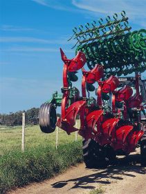 Packers - Kverneland Packomat compact and transported above ground level, dragged by tractor in a folded shape