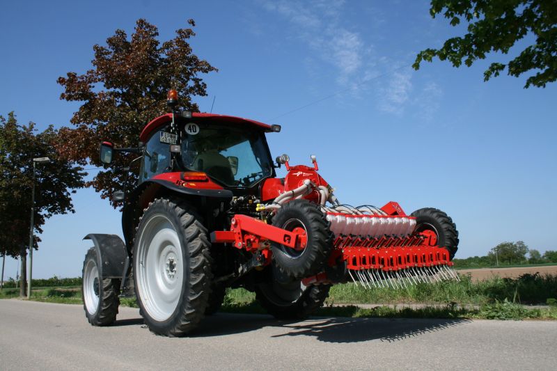 Kverneland Miniair Nova transported on road by tractor