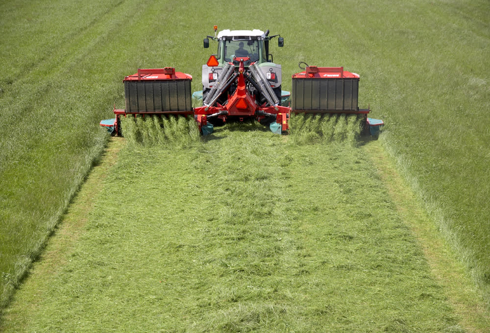 Mower Conditioners - Mower Conditioners - Kverneland 5090 MT operating on field with swath belt and steel tine conditioning