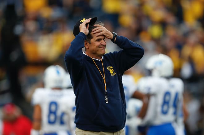 Michigan Wolverines football coach Jim Harbaugh smiling.