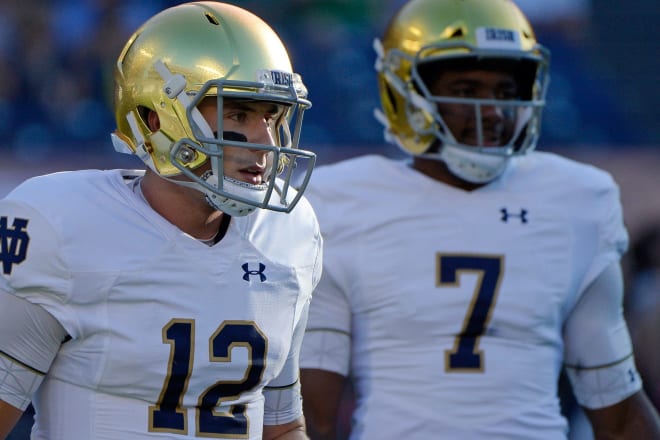 Notre Dame fifth-year senior quarterback Ian Book and former Irish quarterback Brandon Wimbush