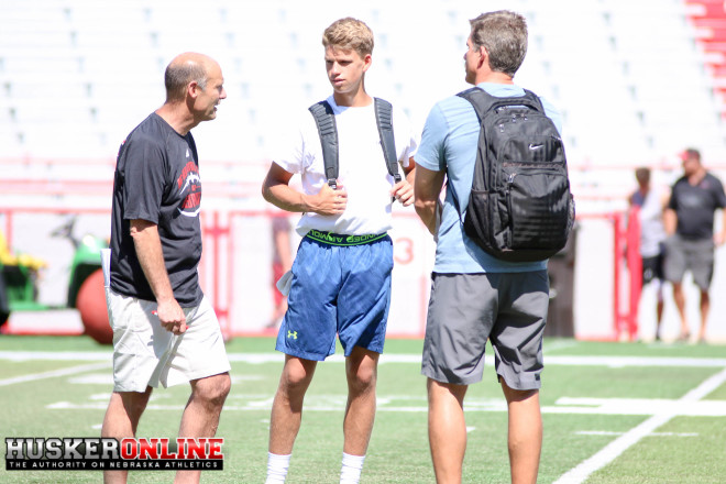Nebraska head coach Mile Riley chats with 2018 quarterback Derek Green and his father, former NFL quarterback Trent Green after today's camp.