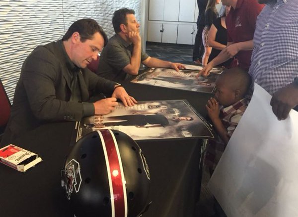 Will Muschamp is autographing 2016 schedule posters at every Spurs Up tour stop 