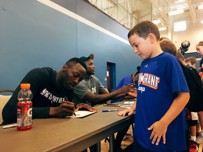 Jerian Grant signs an autograph for Brady Nitz at the conclusion of Sunday's camp session.
