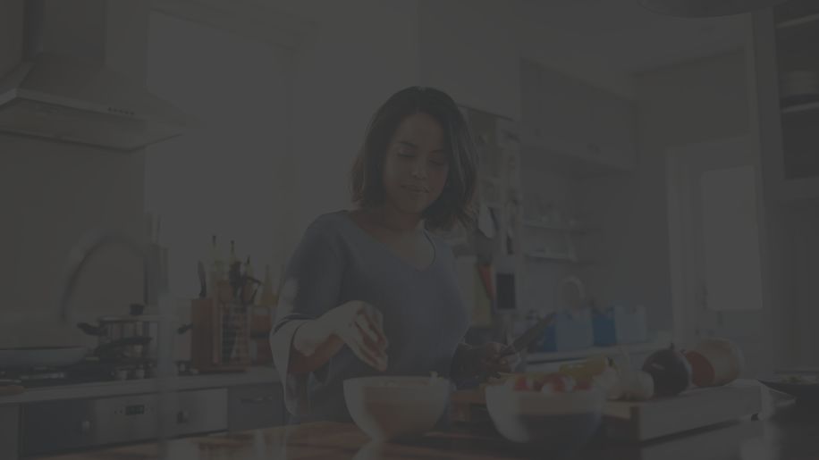 woman cutting up vegetables in the kitchen