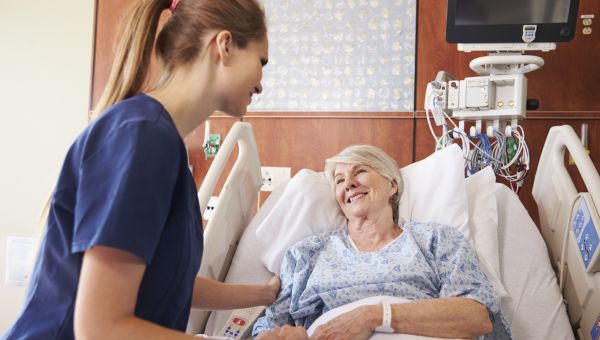 nurse comforting a patient in bed