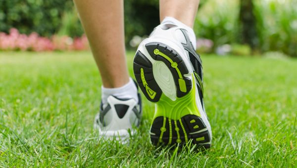 tennis shoes walking in the grass