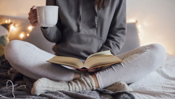 woman sitting in bed reading