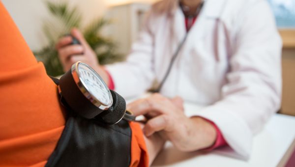 doctor reading blood pressure