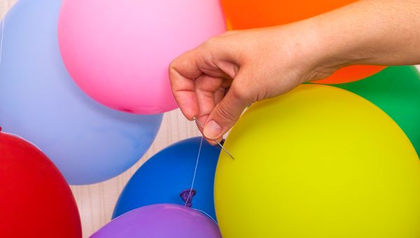 person popping a balloon