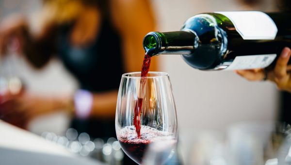 red wine being poured into a glass