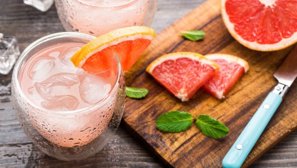 grapefruit, beverage, cutting board, knife