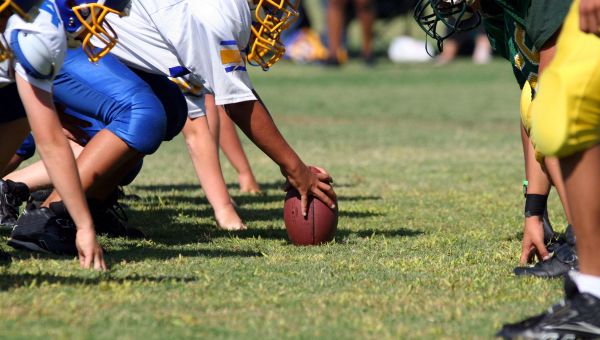 young men playing football, group playing football