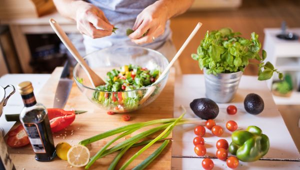 woman preparing veggies, fresh salad, fruits and vegetables