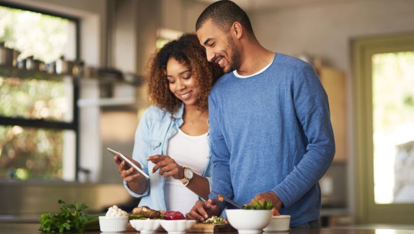 happy couple preparing dinner