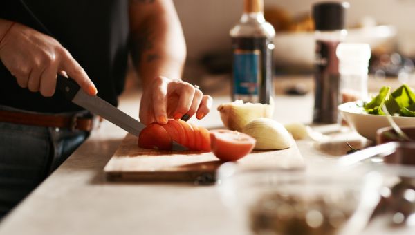 woman chopping up carrots