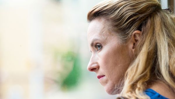 middle-aged person looking as if they are thinking about something