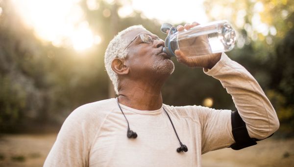 Senior man drinking from bottle of water