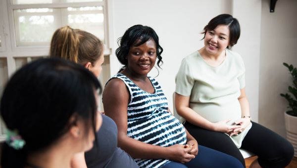 Pregnant mothers discussing breastfeeding