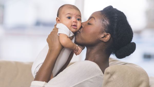 Woman kissing baby on cheek