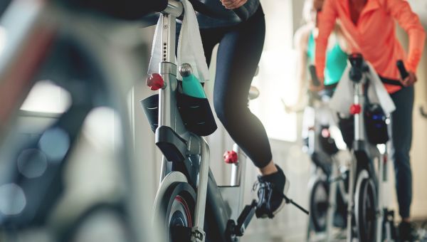 Couple riding stationary bikes together