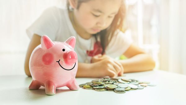 girl counting money, piggy bank