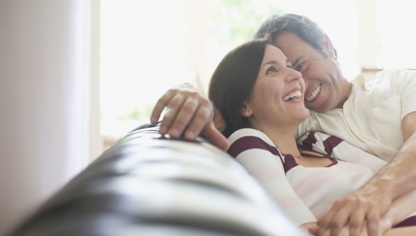 Couple relaxing in living room.