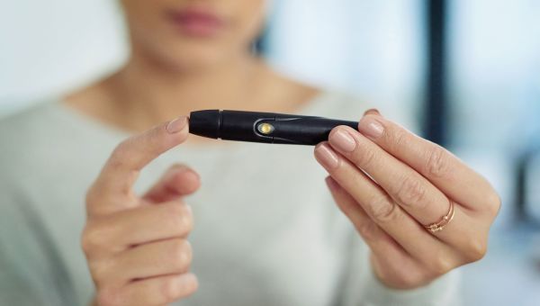 Woman testing her blood sugar level