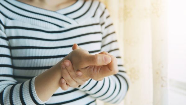 Woman massaging her arthritic hand and wrist