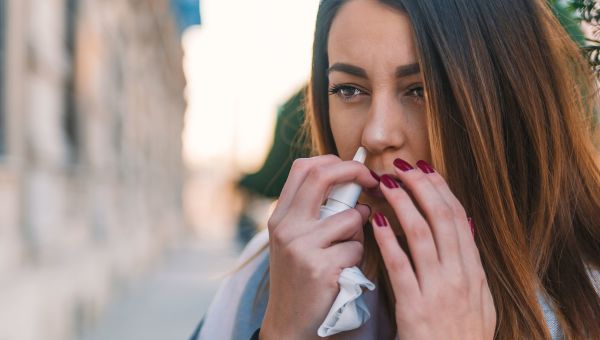 woman using nasal spray