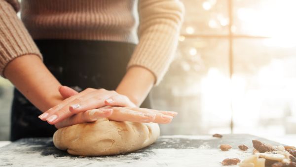 Female hands squishing dough