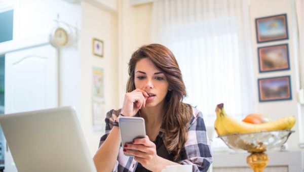 woman on phone and laptop