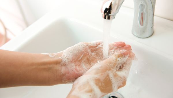 washing hands in white sink