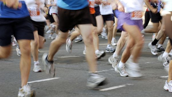 Blurred legs of runners during race