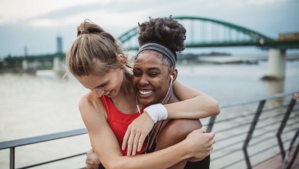 Two female runners hugging