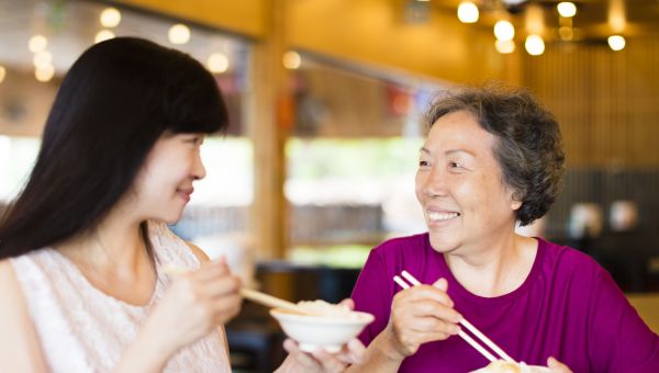 Asian woman and mother grandmother eating
