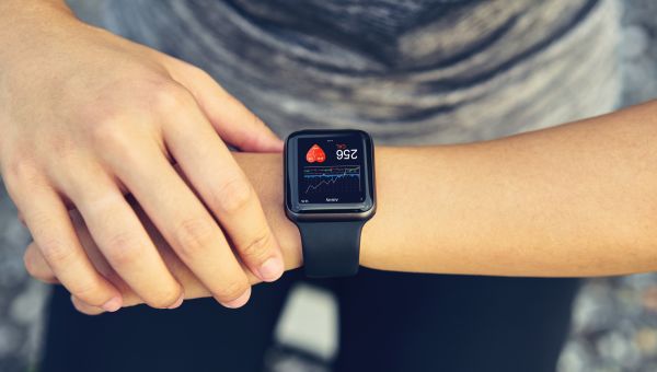 man checking heart rate on smart watch