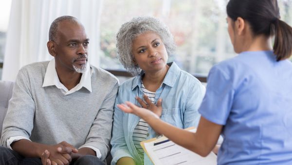 Nurse talking with senior patients