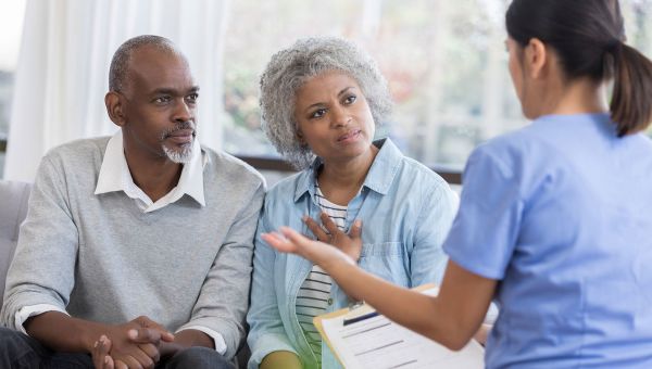 Nurse talking with senior patients