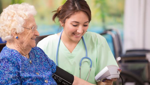 nurse checking blood pressure