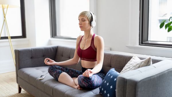 woman meditating on couch