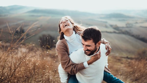 Older couple laughing outside